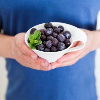 Man holding blueberries