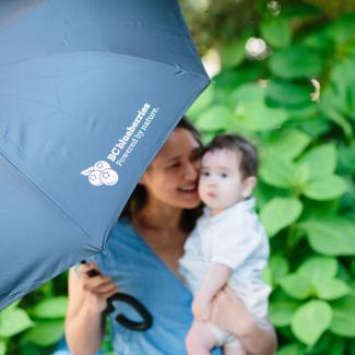 Baby and mother with umbrella